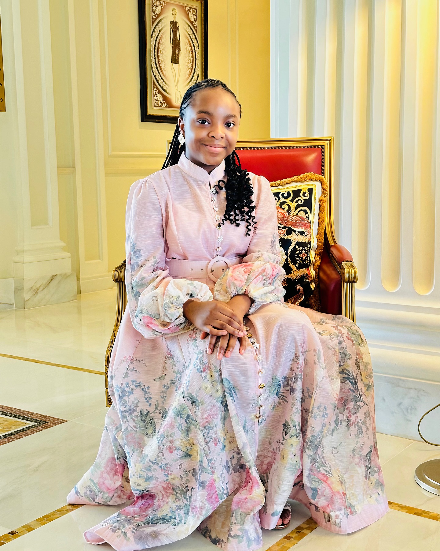 Zahra dressed elegantly, sitting with confidence